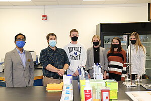 A lab team at Mayville State University stands together in the lab.